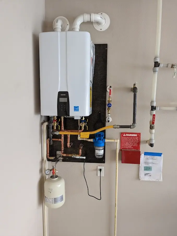 Professional plumber installing copper piping in a Epsom home